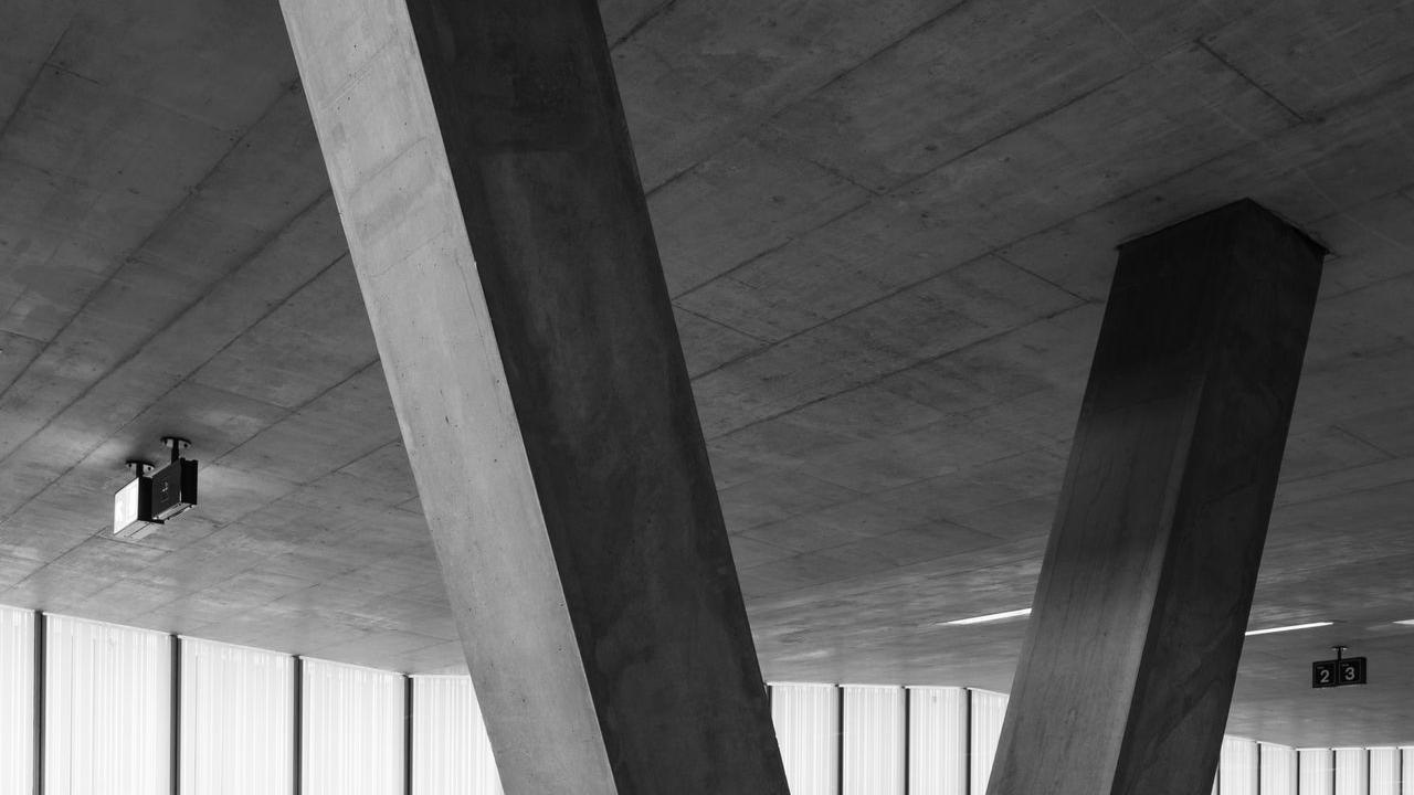 grayscale photo of man walking on hallway