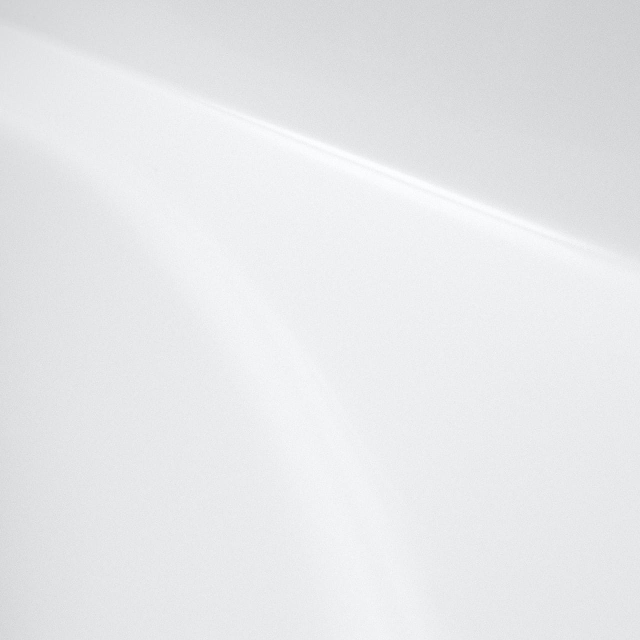 a black and white photo of a white wall